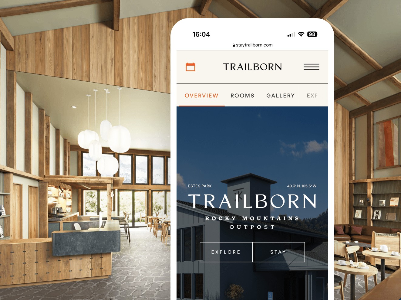 An iphone against the interior of a vacation home. Iphone screen shows the Trailborn app, with white text overlaid on a darkened image of a home and a blue sky. Buttons read "Explore" and "Stay."