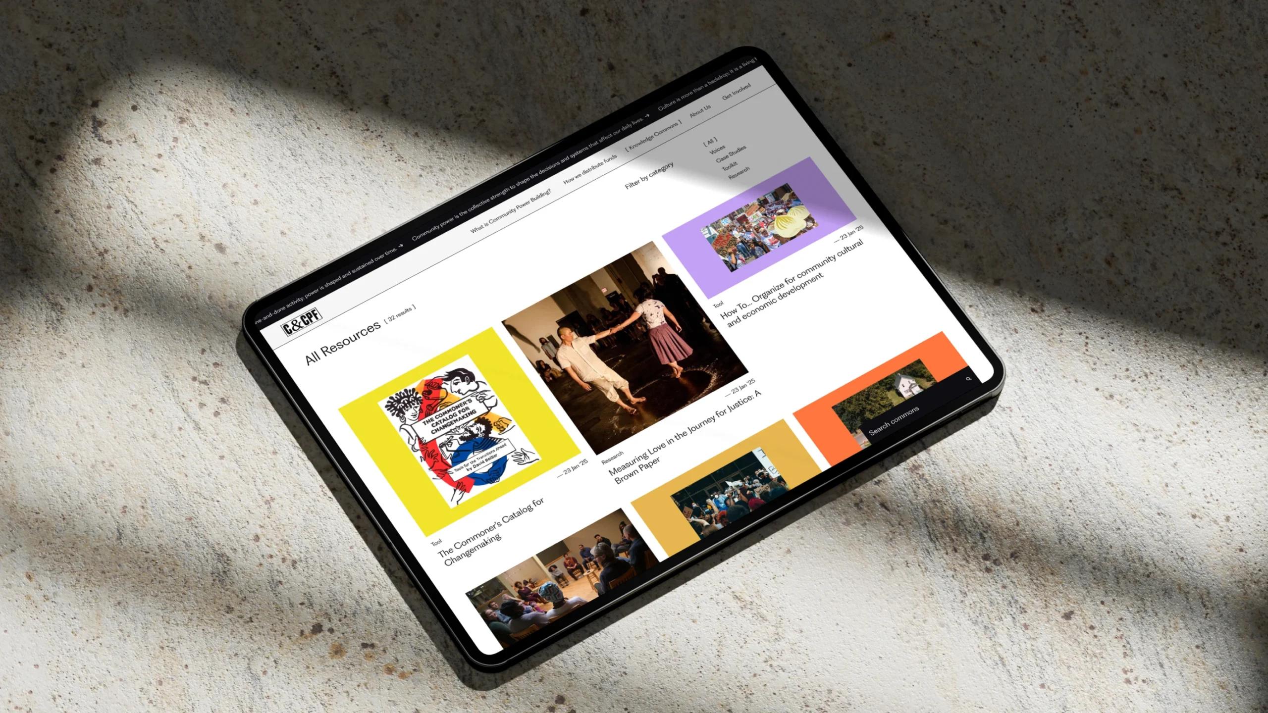 The Knowledge Commons on an iPad, which appears as squares of article previews featuring the headlines and images on yellow, purple, and orange backgrounds